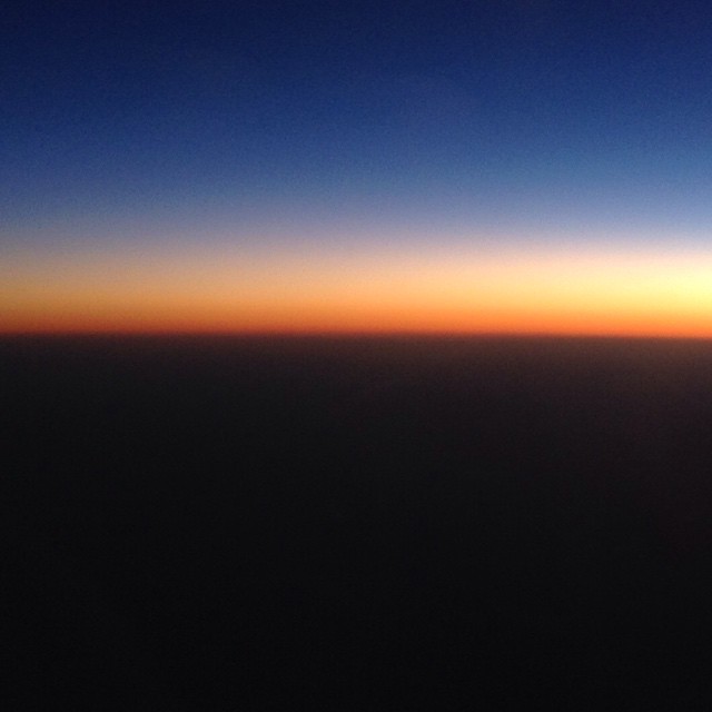 Sunrise from an airplane flying over Australia.
